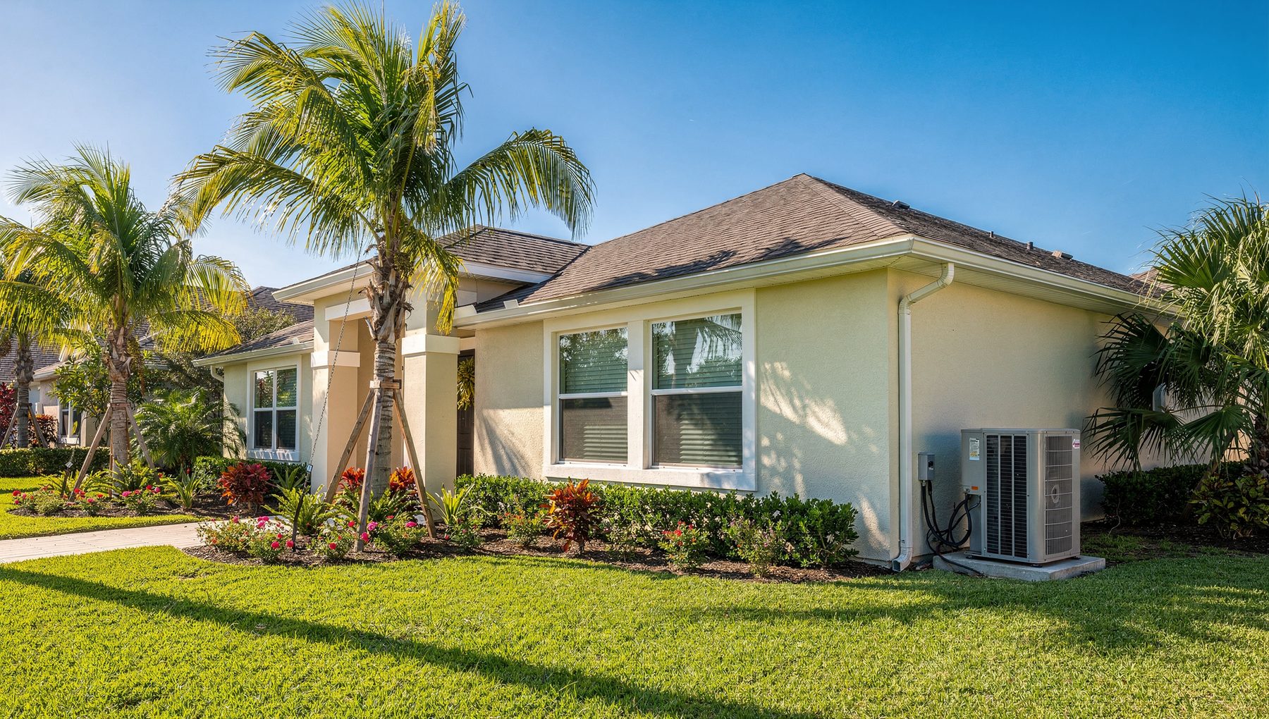 A bright Jacksonville home in the Florida sunshine with palm trees and a clean outdoor AC unit